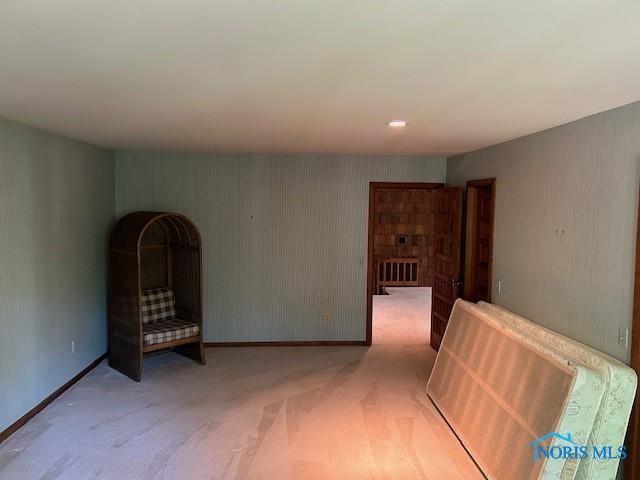 interior space featuring carpet and baseboards