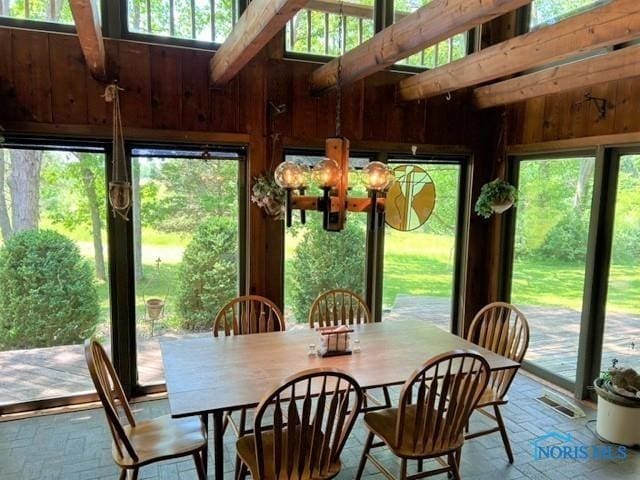 sunroom with a chandelier and visible vents