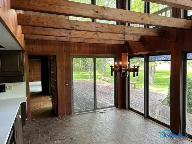 doorway to outside featuring wooden walls