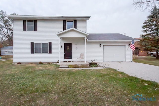 view of front of property with a garage and a front yard