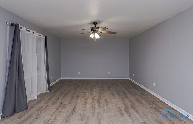 spare room featuring hardwood / wood-style floors and ceiling fan