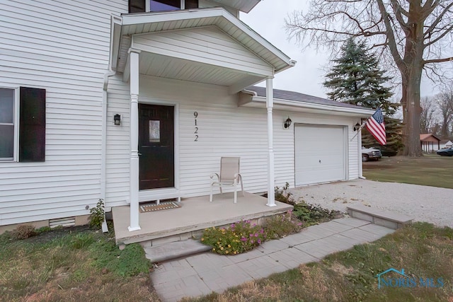 doorway to property with a garage