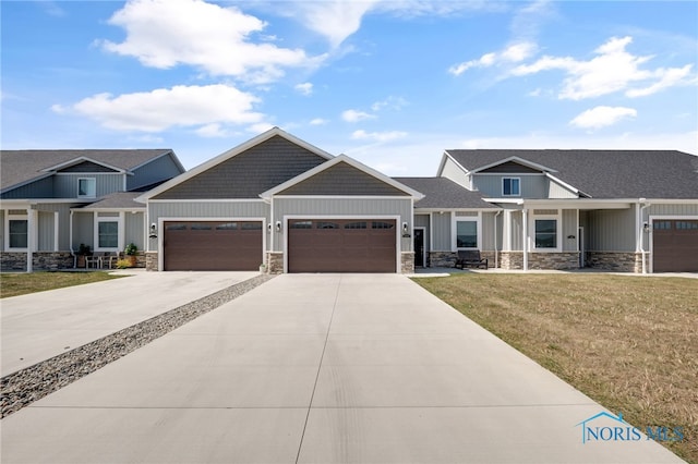 craftsman-style home featuring a garage and a front yard