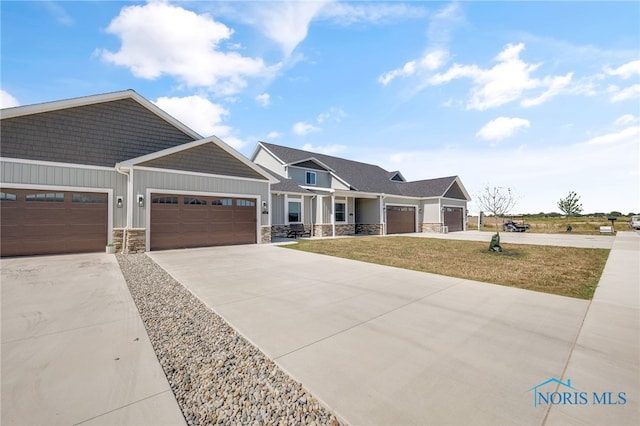 craftsman-style home featuring a garage and a front yard