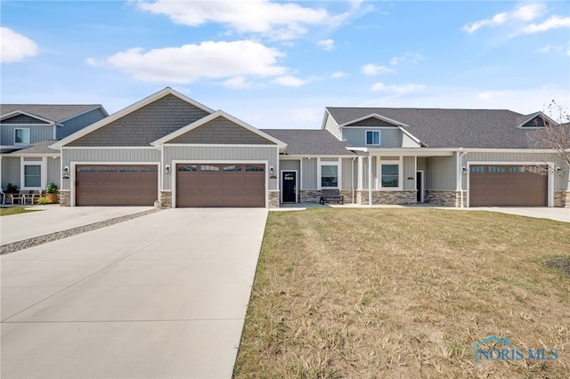 craftsman-style home with a garage and a front yard