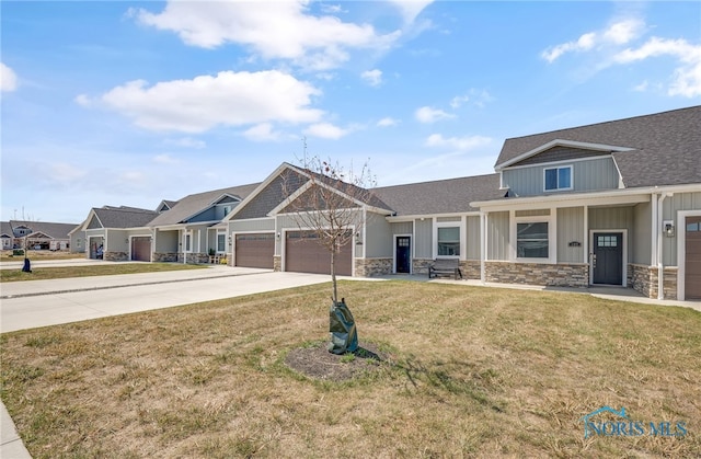 craftsman-style home with a garage and a front lawn