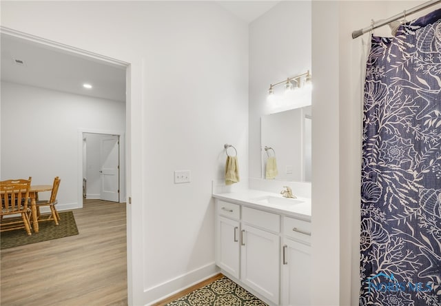 bathroom featuring vanity and wood-type flooring