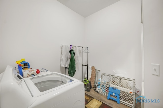 laundry room with hardwood / wood-style floors and washer and dryer