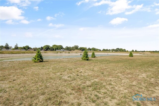 view of yard featuring a water view and a rural view