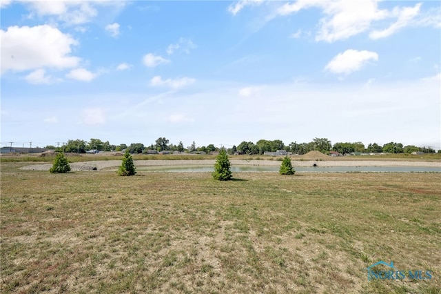 view of yard featuring a rural view and a water view