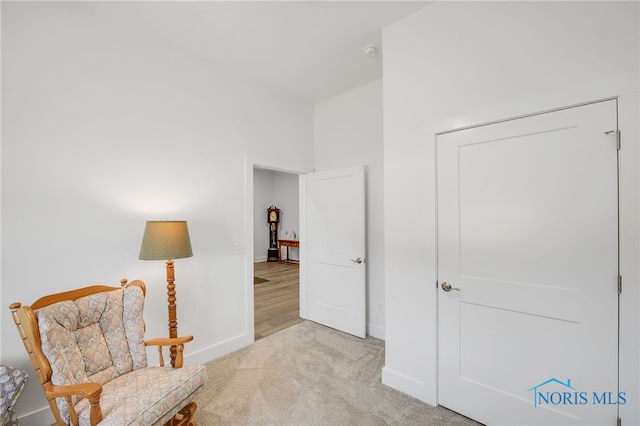 sitting room featuring light colored carpet