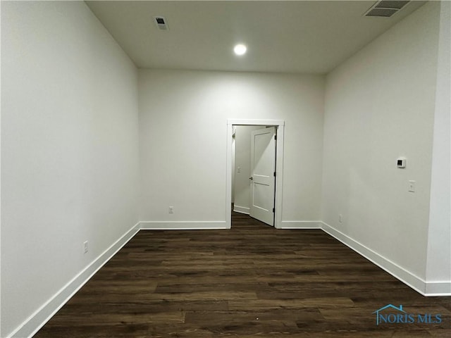 empty room with dark hardwood / wood-style floors