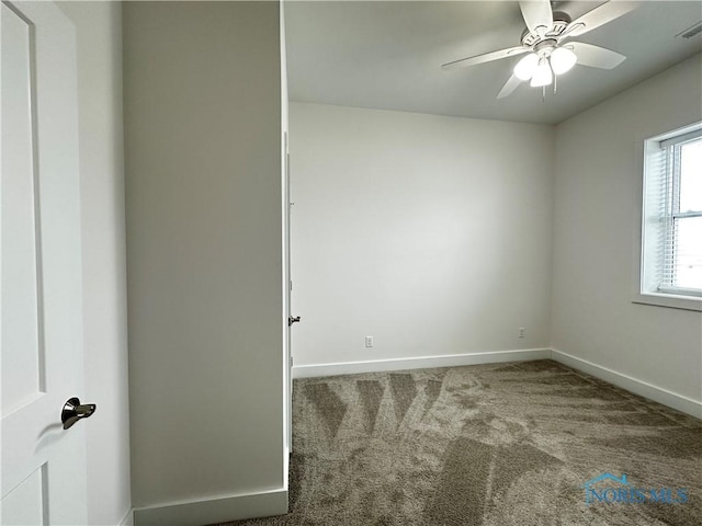 carpeted empty room featuring ceiling fan