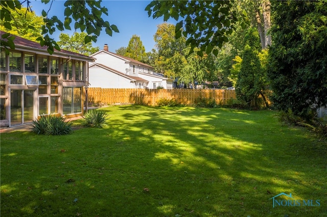 view of yard with a sunroom