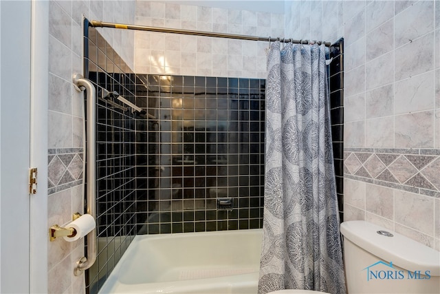 bathroom featuring shower / bath combo with shower curtain and toilet