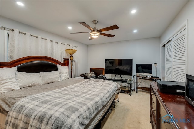 carpeted bedroom with a closet and ceiling fan