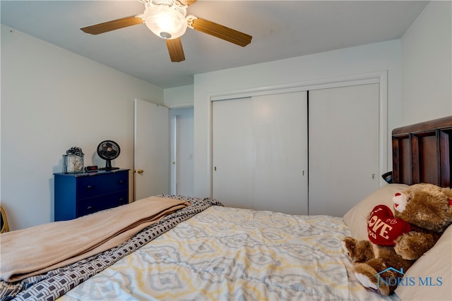 bedroom featuring ceiling fan and a closet