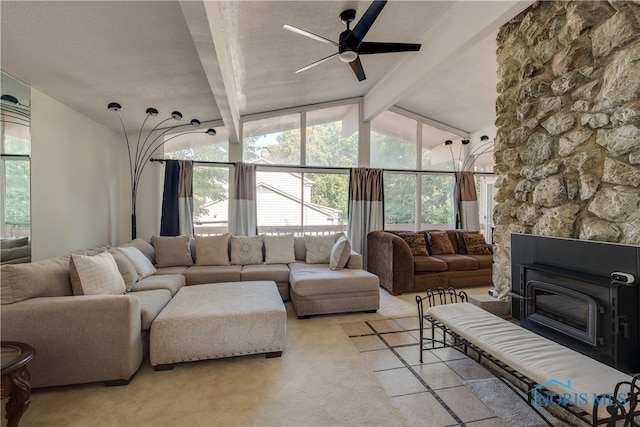 living room with a textured ceiling, a large fireplace, ceiling fan, and vaulted ceiling with beams