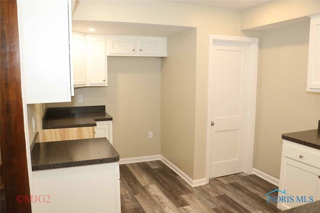 kitchen featuring dark wood-type flooring and white cabinetry