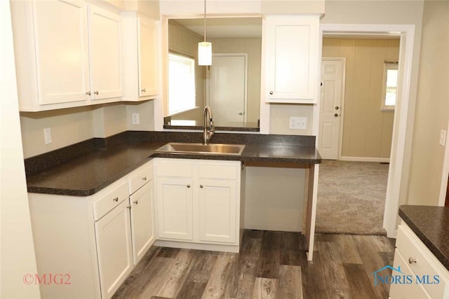 kitchen featuring pendant lighting, sink, dark hardwood / wood-style flooring, and white cabinets