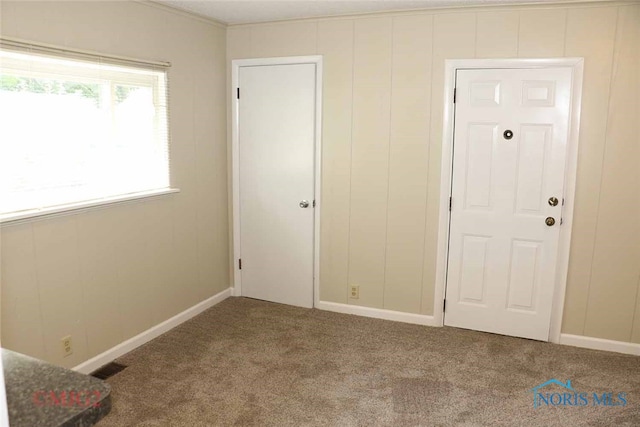 unfurnished bedroom with carpet floors