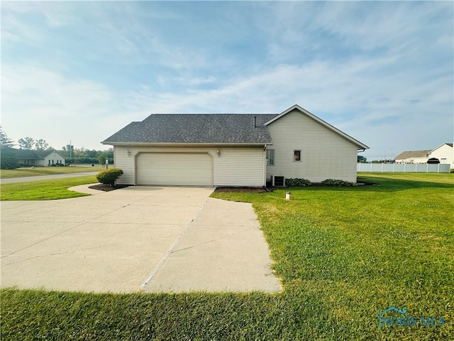 view of side of home with a garage and a lawn