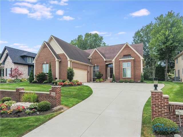 view of front of property featuring a front yard and a garage