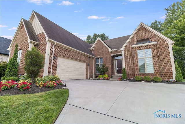 view of front of house with a garage and a front lawn