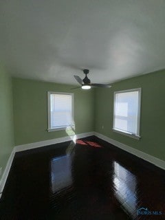 spare room with wood-type flooring and ceiling fan