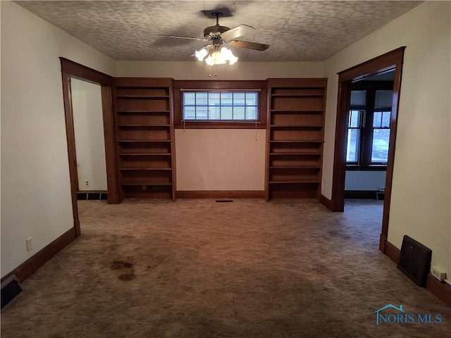 carpeted spare room with ceiling fan and a textured ceiling