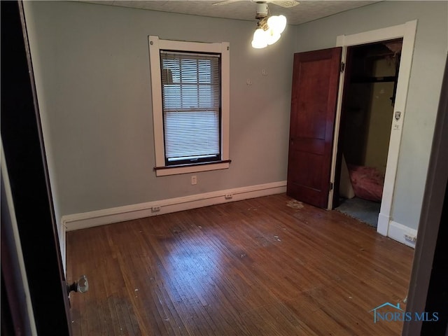 unfurnished bedroom featuring a textured ceiling and dark hardwood / wood-style floors