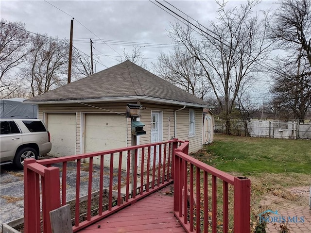 exterior space with a yard and a garage