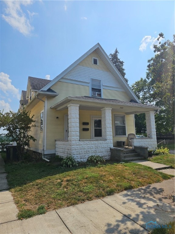 bungalow-style house with a porch and a front yard