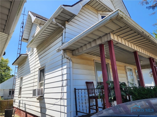 view of property exterior with cooling unit and covered porch