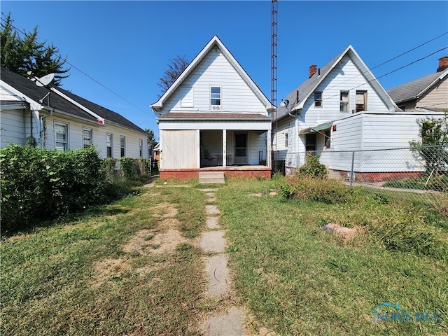 back of house with a lawn