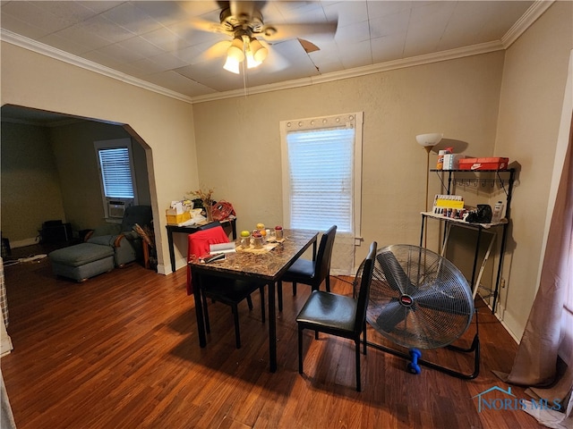 dining room featuring crown molding, dark wood-type flooring, and ceiling fan