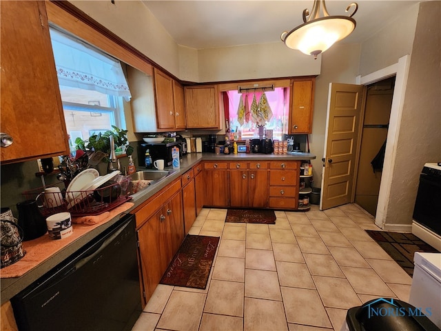 kitchen featuring black dishwasher, hanging light fixtures, stove, and light tile patterned flooring