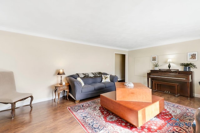 living room with hardwood / wood-style flooring and ornamental molding