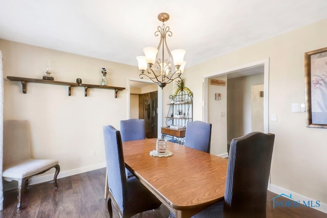 dining space with a chandelier and dark hardwood / wood-style floors