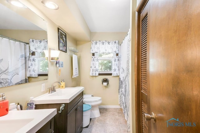 bathroom featuring vanity and toilet