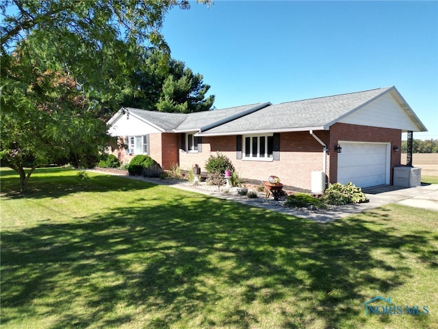 single story home with a garage and a front yard