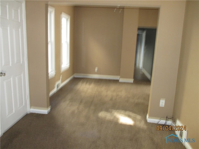 unfurnished room featuring carpet