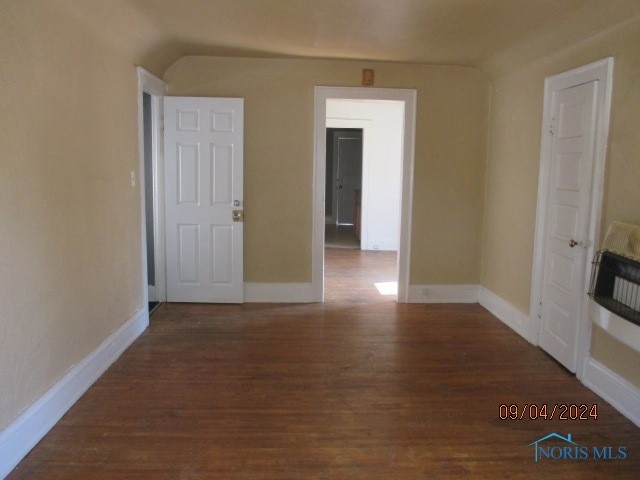 unfurnished room with dark hardwood / wood-style floors