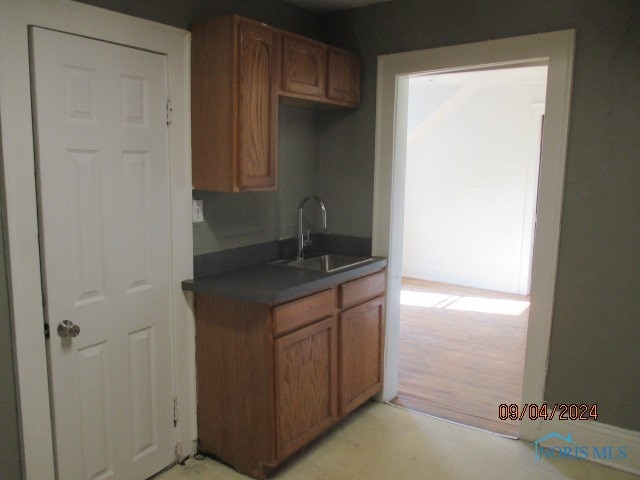 kitchen with light hardwood / wood-style flooring and sink