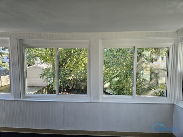 unfurnished sunroom with a wealth of natural light