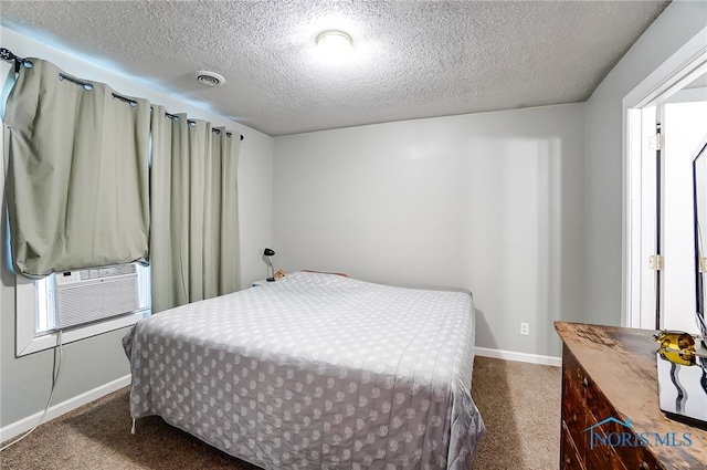 bedroom with dark carpet, cooling unit, and a textured ceiling