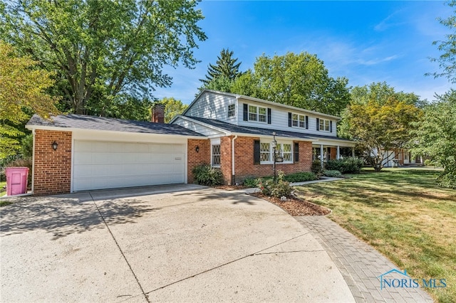 front facade featuring a front lawn and a garage