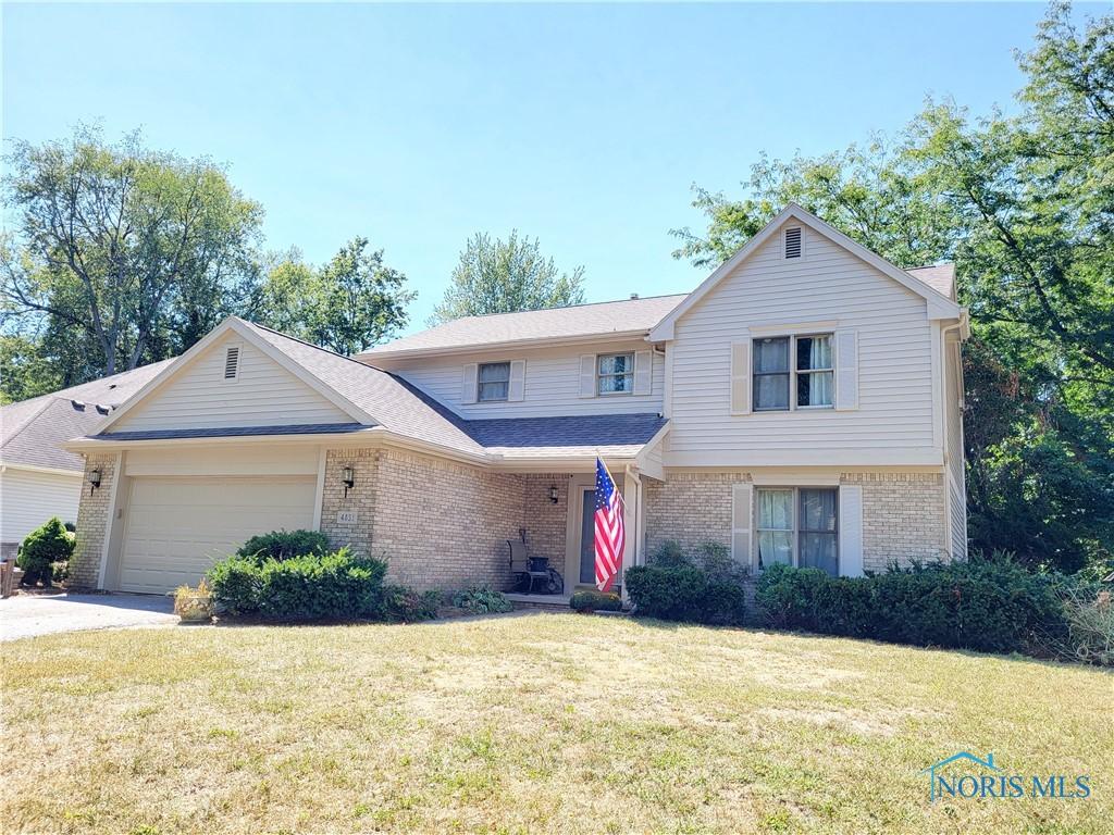 view of front property with a front yard and a garage