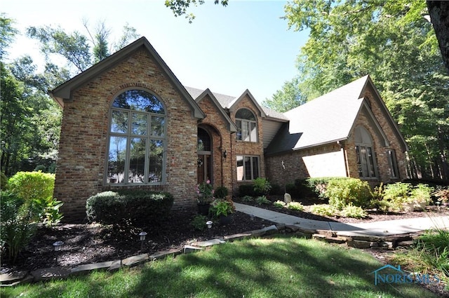 english style home featuring a front lawn