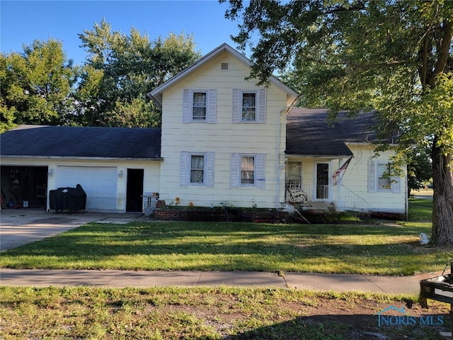 view of front of property with a front lawn and a garage